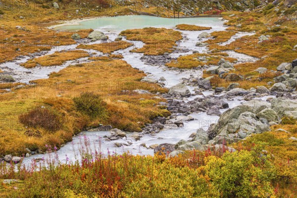 A glacier stream flows from Lac de Chateaupre into the Lac de Moiry reservoir, Val d'Anniviers, Valais Alps, Canton of Valais, Switzerland