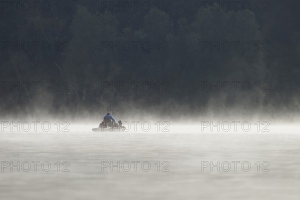 Hennesee, fog, rising clouds of fog, anglers in the boat, Hennetalsperre, Sauerland-Rothaargebirge nature park Park, North Rhine-Westphalia, Germany