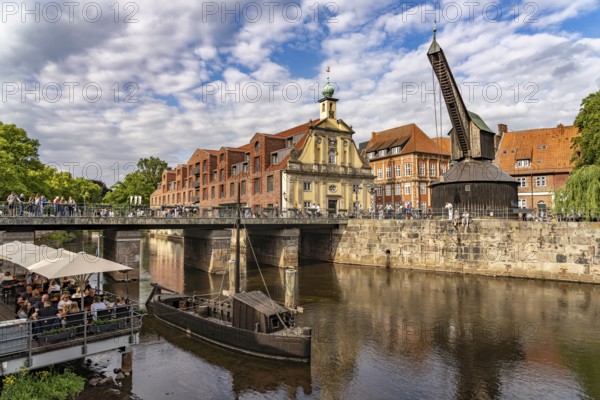 Old harbour with crane and hotel department store in the Hanseatic city of Lüneburg, Lower Saxony, Germany
