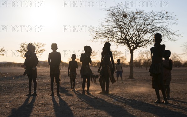 Himba children playing, evening mood, traditional Himba village, Kaokoveld, Kunene, Namibia