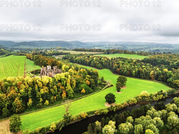 Autumn Colours over ruins of Goodrich Castle and River Wye from a drone, Goodrich, Herefordshire, England, United Kingdom