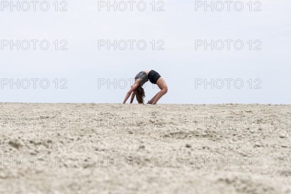 Abstract, woman doing gymnastics in a whirring landscape, Etosha pan, Etosha National Park, Namibia