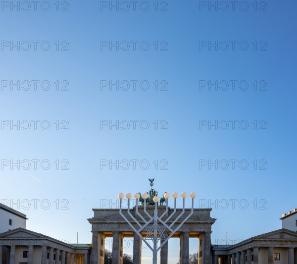 Large Hanukkah chandelier at the Brandenburg Gate in daylight, sign of lively Jewish life, symbolic power for 20 years, Berlin, Germany