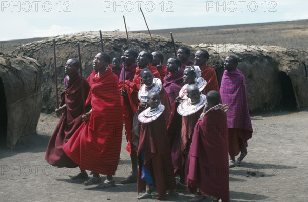 Maasai men and girls in their village in the Ngorongoro Crater dancing for tourists, Tanzania, Africa, June 2000, vintage, retro, old, historic