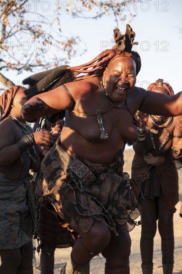 Himba woman dancing euphorically, traditional dance, traditional Himba village, Kaokoveld, Kunene, Namibia