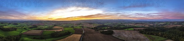 Sunset of Devon Farms and Fields over Berry Pomeroy from a drone, Totnes, England, United Kingdom
