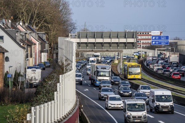 Residential buildings directly on the A40 motorway, noise barrier, heavy traffic near the Essen-Ost motorway junction, view to the west, 6-lane motorway, with 2 bus lanes in the middle, rush hour traffic, North Rhine-Westphalia, Germany
