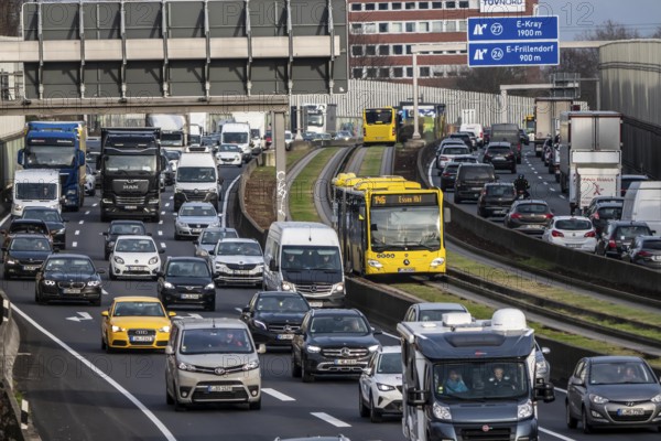 Heavy traffic on the A40 motorway, Ruhrschnellweg, height of the Essen-Ost motorway junction, looking east, 6-lane motorway, with 2 bus lanes in the middle, rush hour traffic, North Rhine-Westphalia, Germany