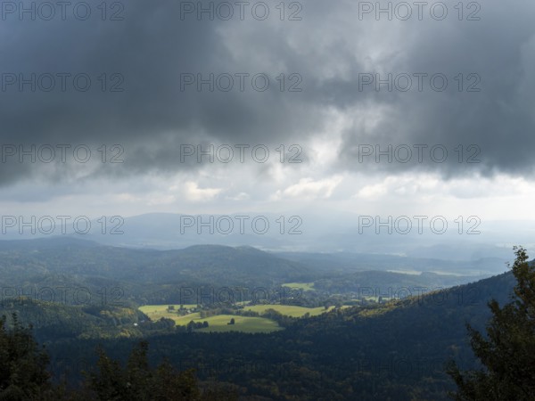 Dramatic weather with dark clouds over low mountain ranges, Bohemian Lusatia, Czech Republic