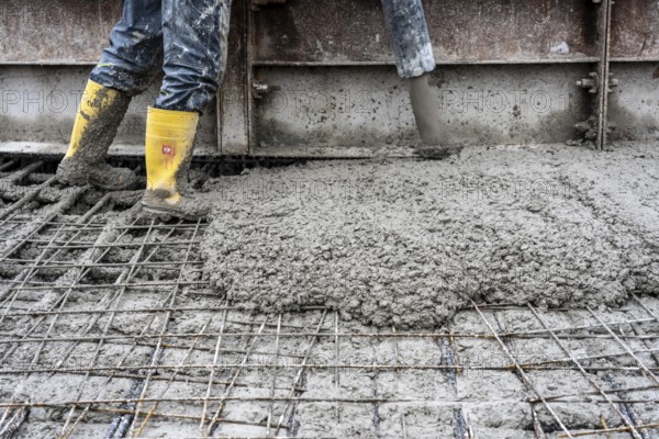 Concreting, concreting the foundation of a wind turbine, concrete pump hose, more than 600 cubic meters of concrete will be pumped into the foundation for over 7 hours, over 100 tons of reinforcing steel have been used, the wind turbine will have a hub height of 160 meters, part of a new wind farm in Sauerland, near Balve, North Rhine-Westphalia, Germany