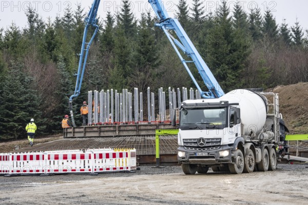 Concreting, concreting the foundation of a wind turbine, more than 600 cubic meters of concrete will be pumped into the foundation for over 7 hours, over 100 tons of reinforcing steel have been used, the wind turbine will have a hub height of 160 meters, part of a new wind farm in Sauerland, near Balve, North Rhine-Westphalia, Germany