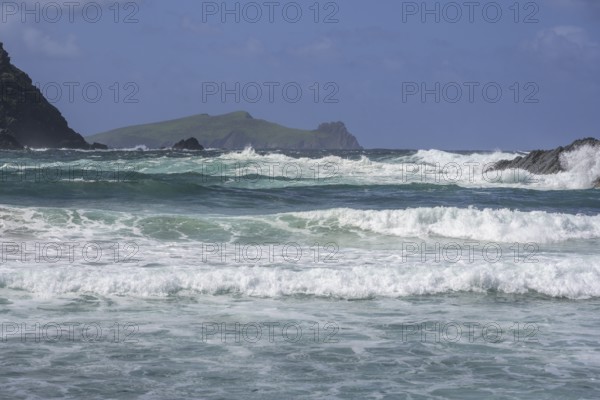 Waves crashing against cliffs in the background Inishtooskert Island (sleeping Giant), Clogher Strand, Dunurlin, Kerry, Ireland