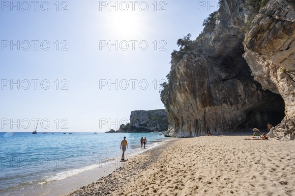 Sandy beach beach and steep cliffs with caves at Cala Luna, Golfo di Orosei, Baunei, Sardinia, Italy