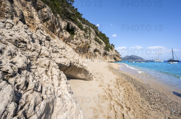 Sandy beach beach and steep cliffs at Cala Luna, Golfo di Orosei, Baunei, Sardinia, Italy