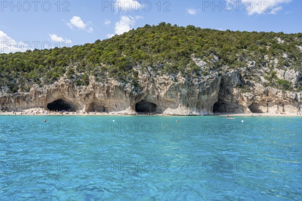 Clear blue water and picturesque rocky coast, Cala Luna cliffs and beach, Golfo di Orosei, Baunei, Sardinia, Italy