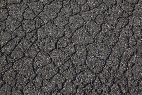 Top view and close-up of cracked asphalt road surface, Quebec, Canada