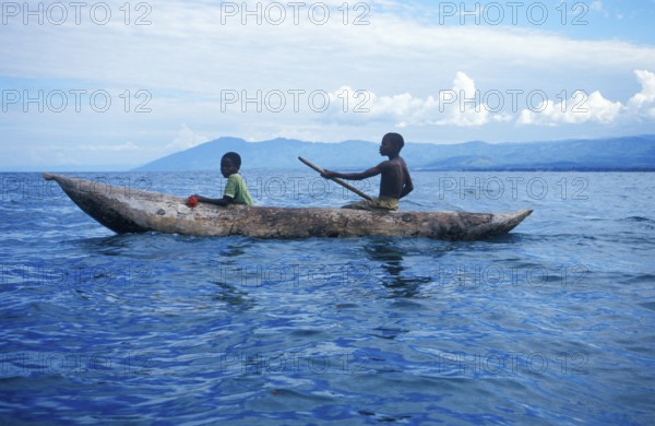 Two boys in a dugout on Lake Malawi, Malawi, Africa, July 2000, vintage, retro, old, historic