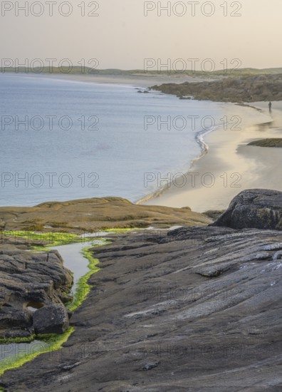 Granite rocks in the evening light and turquoise blue sea at Gurteen Beach, Roundstone, County Galway, Ireland