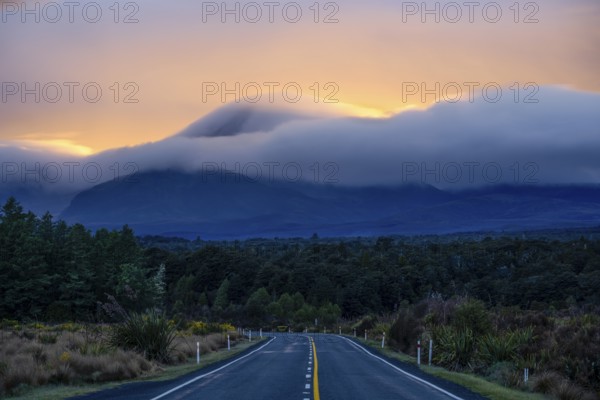 Mount Ngauruhoe in the morning at sunrise with glowing clouds, road SH 47. Tongariro National Park, North Island, New Zealand