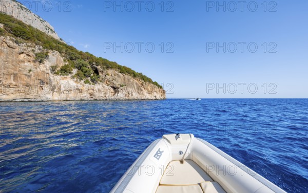 Motorboat trip along the picturesque rocky coast, cliffs and blue sea, Golfo di Orosei, Baunei, Sardinia, Italy