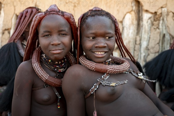 Group of Himba people, Himba woman, traditional Himba village, Kaokoveld, Kunene, Namibia