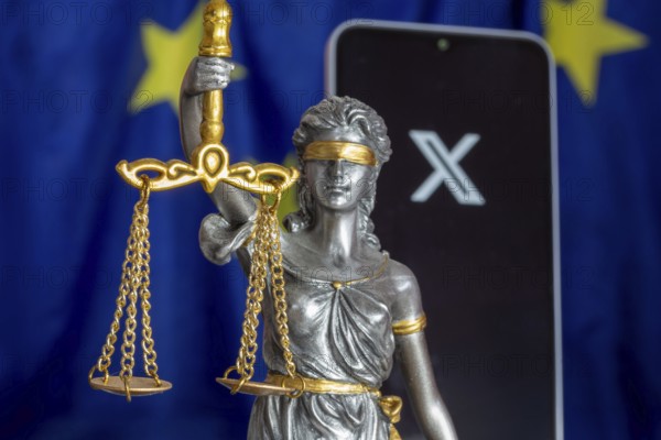 Symbolic picture of the EU Commission's fine against X: Justice, smartphone with logo of X and EU flag