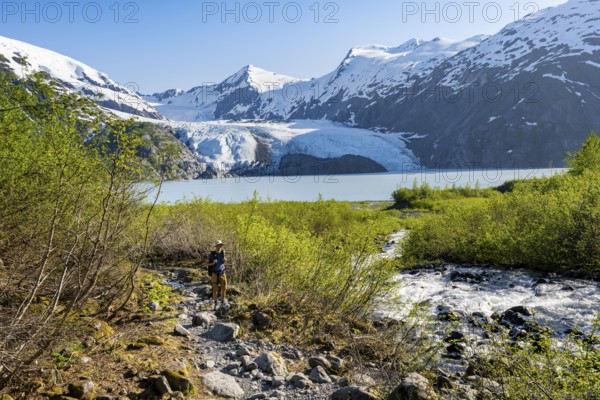 Hikers on the Portage Pass Trail, snowy mountains, Portage Glacier and Portage Lake, near Whittier, Alaska, USA
