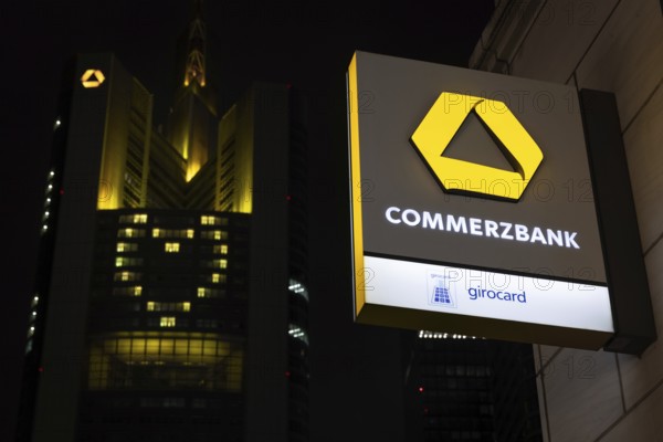 A yellow heart glows on the façade of the Commerzbank Tower in Frankfurt am Main at Christmas time in the evening, Frankfurt am Main, Hesse, Germany