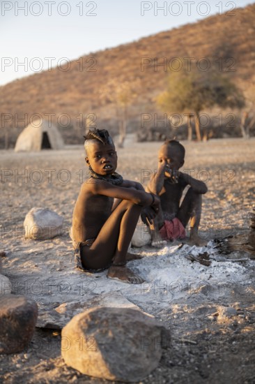 Himba children at the fire early in the morning, traditional Himba village, Kaokoveld, Kunene, Namibia