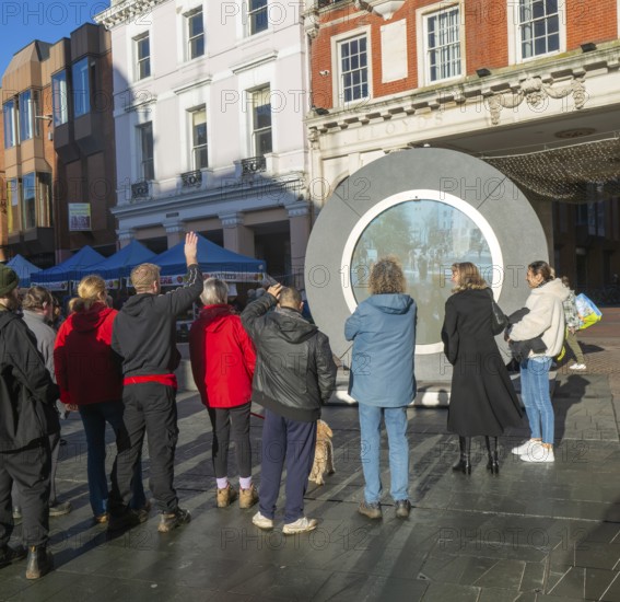People on the Cornhill in the town centre view the first ever UK Portal in Ipswich, Suffolk, England, UK