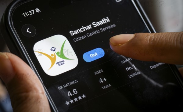 In this photo illustration, a person downloads the Sanchar Saathi mobile application on an iPhone, in New Delhi, India on 3 December 2025. Sanchar Saathi is officially developed and operated by the Department of Telecommunications (DoT), Government of India as part of its citizen-protection and telecom-security initiative