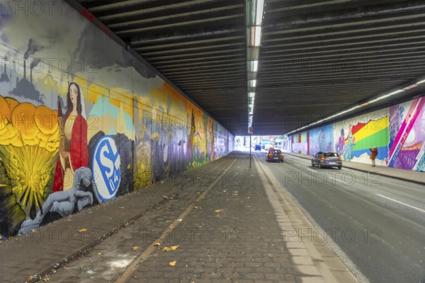 Huge street art pictures in a road tunnel in Gelsenkirchen, the approximately 120 meter long railway underpass of Wickingstraße was extensively painted and sprayed on both sides by 11 Gelsenkirchen graffiti artists and collectives, over a total length of 174 meters, the wall paintings showed motifs from Gelsenkirchen history, from economy, coal, steel, soccer, Schalke 04, culture, life, to the 150.year-old city Anniversary on 29.11.25, North Rhine-Westphalia, Germany