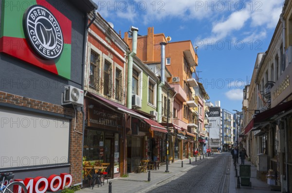 Colourful buildings along a busy shopping street on a sunny day, Yali Street, Canakkale, Marmara Region, Turkey