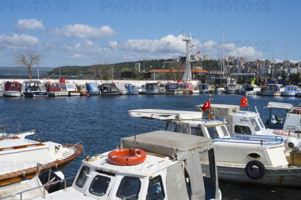 A busy harbor full of boats with flying flags under blue skies, Çanakkale, Canakkale, Marmara region, Turkey