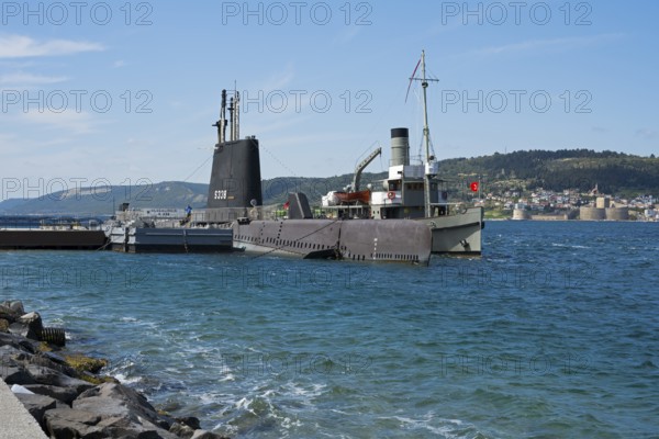A submarine and a ship in the harbor with a view of the city beyond, TCG Uluçalireis S-338, War Museum, in the background Kilitbahir, Çanakkale, Marmara region, Turkey