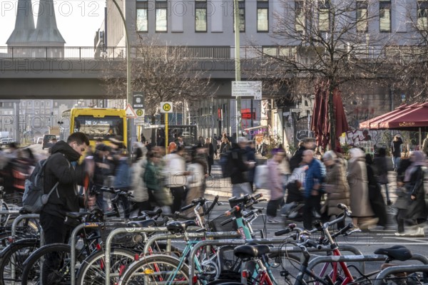 Passers-by on a Grunerstraße pedestrian crossing near Alexander Platz, bicycle parking lot in Berlin, Germany