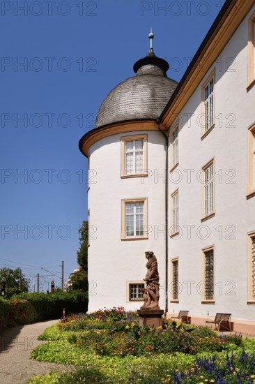 Ettlingen, Germany - August 13th 2025: Side wall of Ettlingen Castle with small garden on sunny day