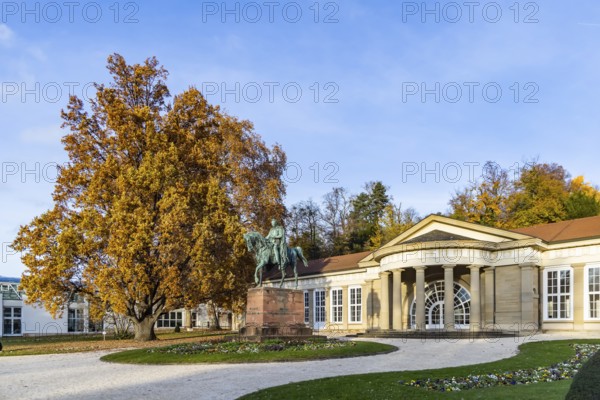 Spa garden Bad Cannstatt in autumn. Large Kursaal with equestrian sculpture of Wilhelm I Stuttgart, Baden-Württemberg, Germany