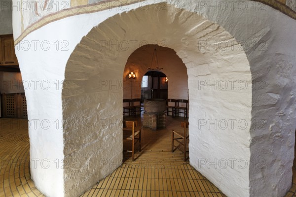 Medieval round church, baptistery with baptismal font, distinctive stone arches, interior, Østerlars church, Østerlars, Bornholm, Denmark