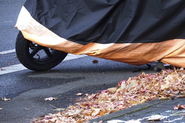 Motor scooter with cover, late autumn, Germany