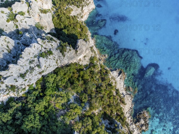 Picturesque rocky coast, blue sea at Cala Goloritzé, top-down, aerial view, Golfo di Orosei, Baunei, Sardinia, Italy