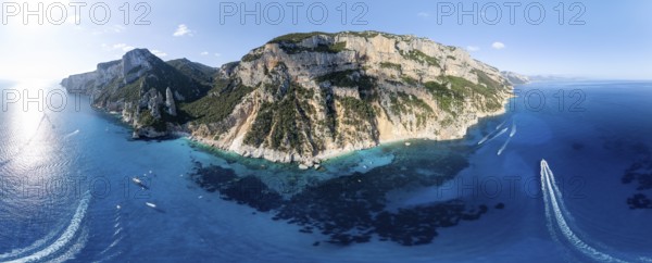 Panorama, picturesque rocky coast, cliffs with L'Aguglia pinnacle, blue sea and Cala Goloritzé beach, aerial view, Golfo di Orosei, Baunei, Sardinia, Italy