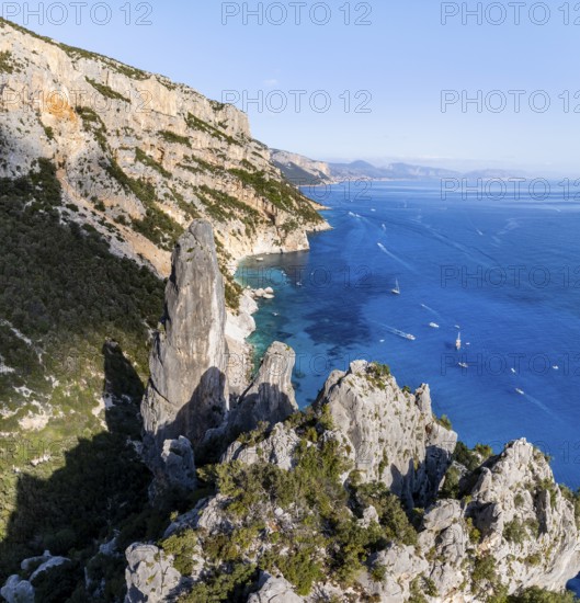 Picturesque rocky coast, cliffs with L'Aguglia pinnacle, blue sea and Cala Goloritzé beach, aerial view, Golfo di Orosei, Baunei, Sardinia, Italy
