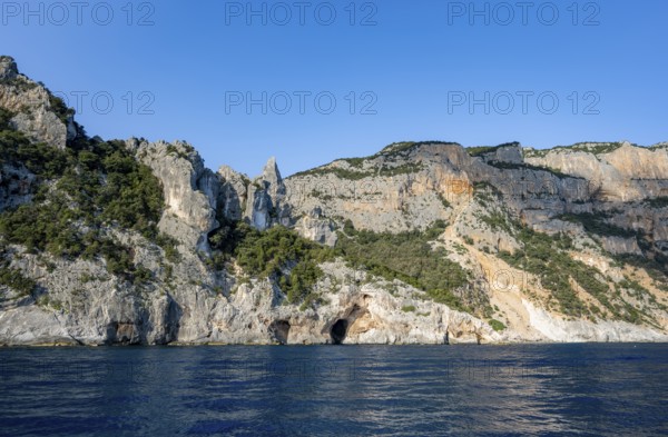 Picturesque rocky coast, cliffs in morning light, blue sea, Golfo di Orosei, Baunei, Sardinia, Italy