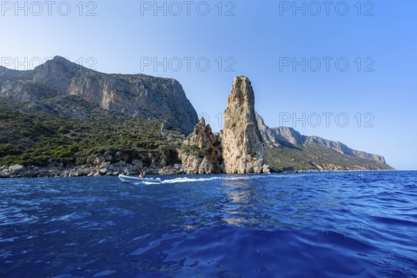 Picturesque rocky coast, cliffs with Pedra Longa pinnacle in the evening light, blue sea, Golfo di Orosei, Baunei, Sardinia, Italy