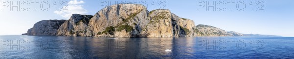 Panorama, motor boat rides in front of picturesque rocky coast ImmorgenLicht, cliffs, Golfo di Orosei, Baunei, Sardinia, Italy