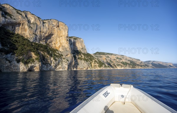 Motorboat trip along the picturesque rocky coast, cliffs and blue sea, Golfo di Orosei, Baunei, Sardinia, Italy