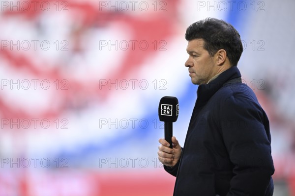 TV expert Michael Ballack interviewed microphone in front of logo FC Bayern Munich, Allianz Arena, Munich, Bavaria, Germany