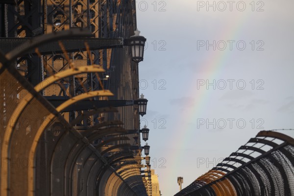 Details of the famous Sydney Harbour Bridge in the evening light with a rainbow