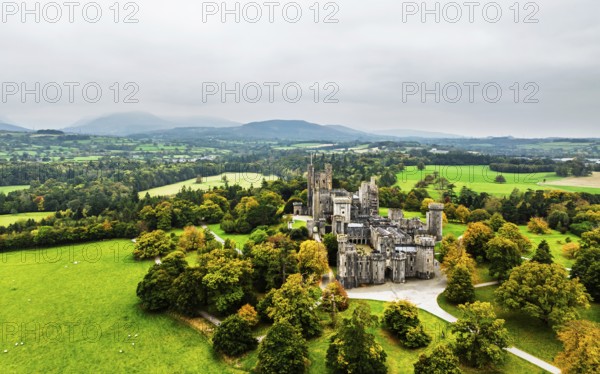 Autumn colours over Penrhyn Castle and Garden from a drone, Llandygai, Bangor, Gwynedd, North Wales, UK